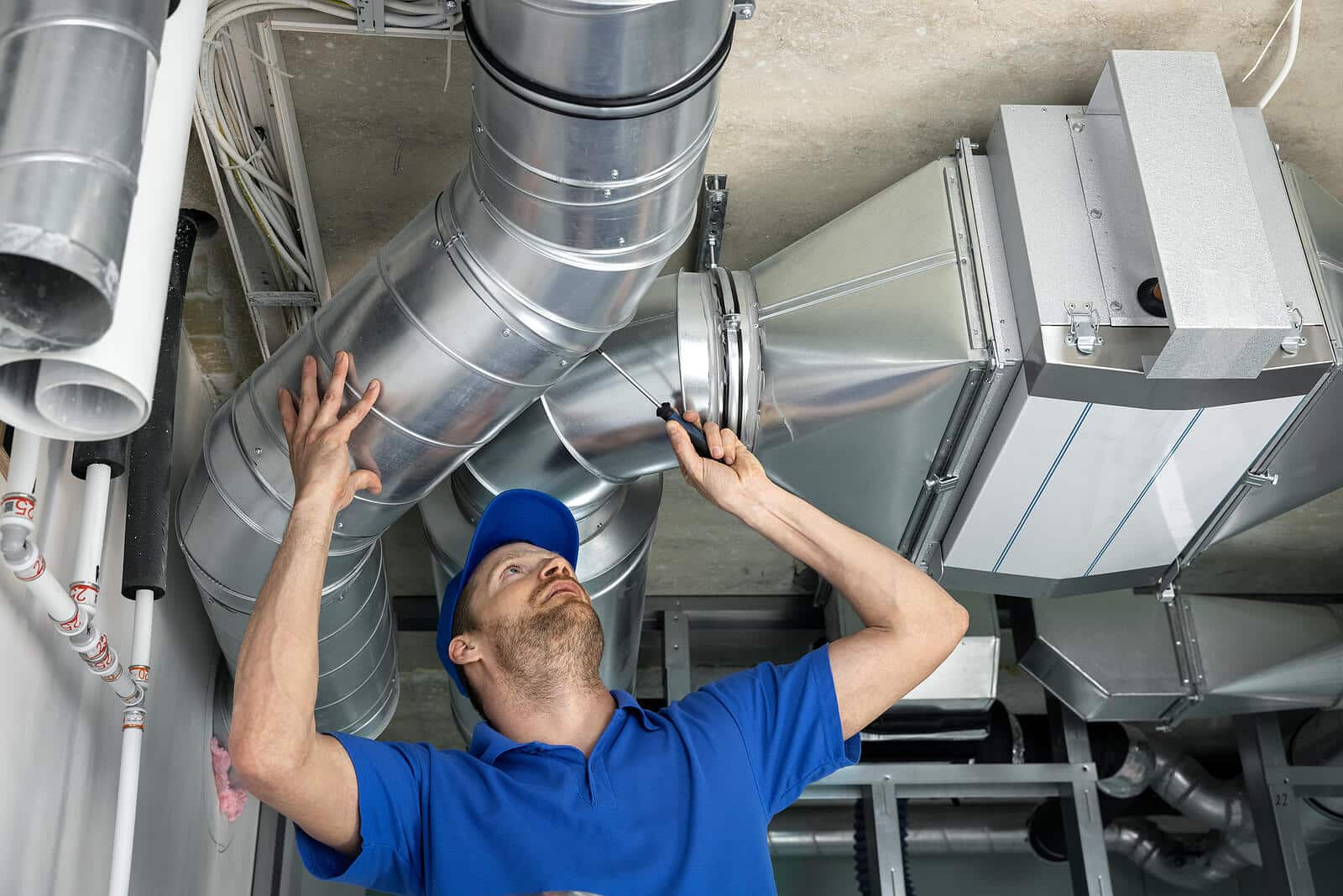 HVAC technician inspecting and repairing air ducts in Selma