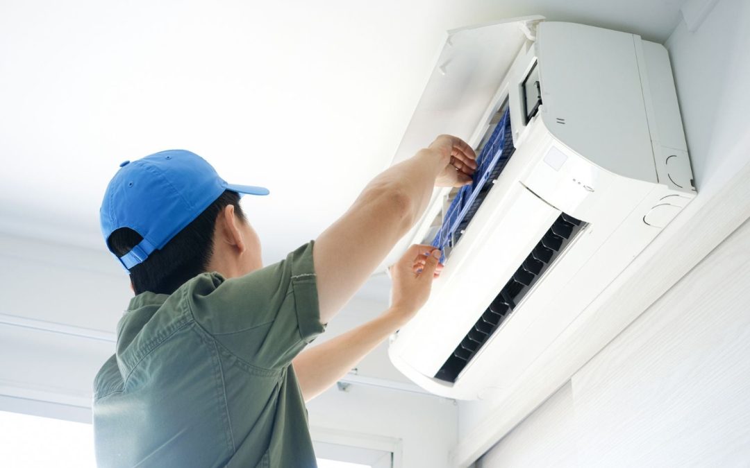 HVAC technician servicing a ductless mini split in Selma