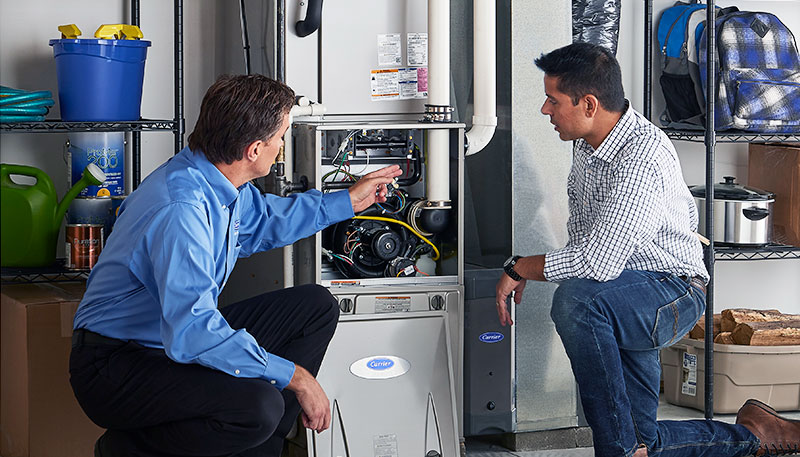 Technician evaluating a furnace for repair or replacement in Selma