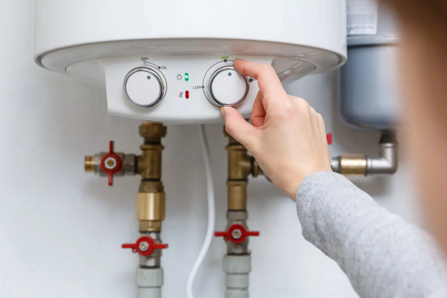 Technician adjusting a water heater in Selma