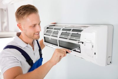 Ductless AC Maintenance Selma HVAC technician maintaining a ductless air conditioner in Selma