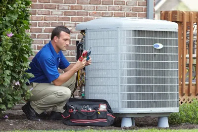 Outdoor AC Unit Inspection Selma HVAC technician inspecting an outdoor AC unit in Selma